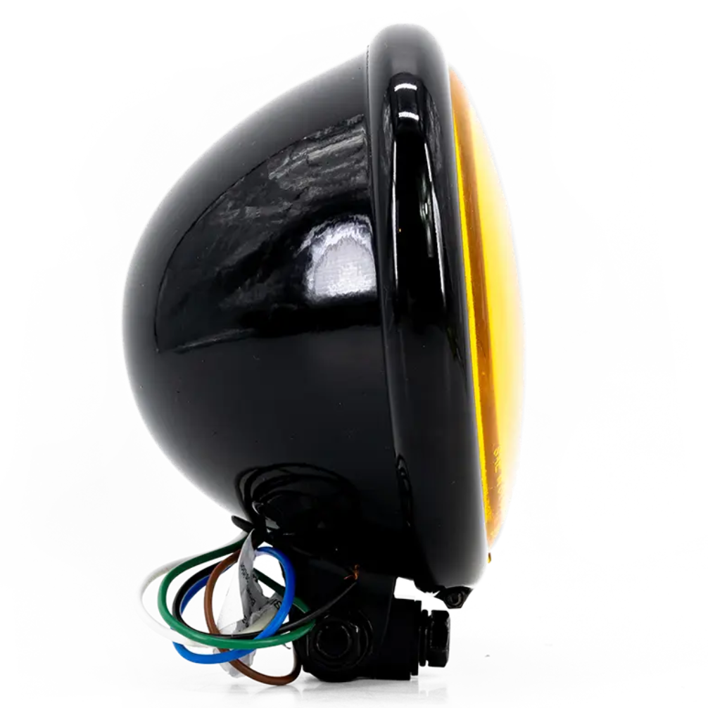 Phare rond Triumph Vintage Bates, optique jaune, corps noir, vue latérale droite soulignant la forme Bates.